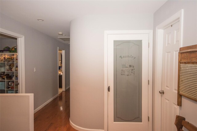 hallway featuring baseboards, wood finished floors, and recessed lighting