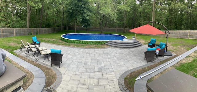view of swimming pool with a fenced backyard, a patio area, a yard, and a fenced in pool