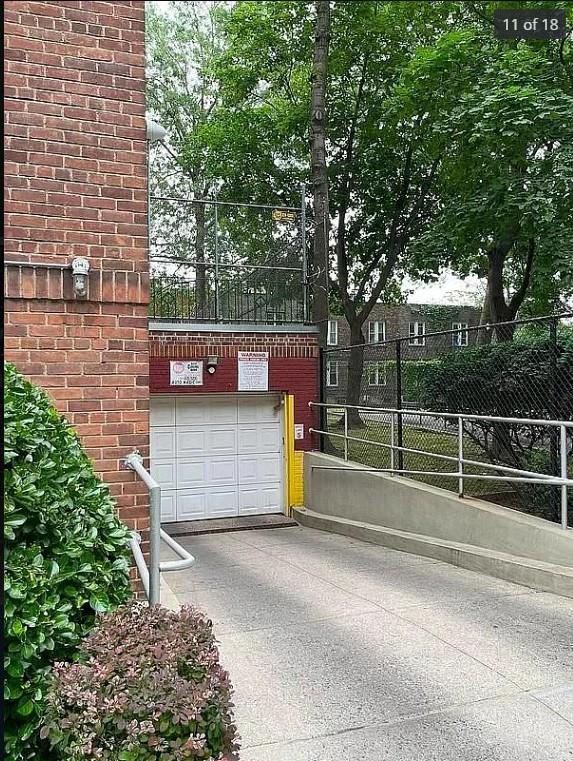 1430 Thieriot Ave Unit 1M, Bronx, NY 10460 - garage with concrete driveway and fence