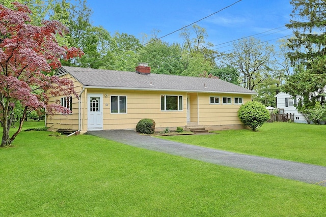 120 Locust Dr, Nyack, NY 10960 - back of property featuring a chimney, roof with shingles, and a lawn
