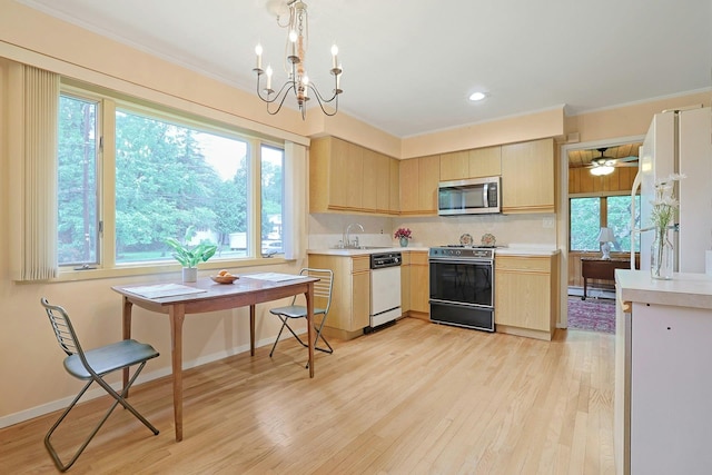 120 Locust Dr, Nyack, NY 10960 - kitchen featuring white appliances, light brown cabinetry, light countertops, light wood-type flooring, and crown molding