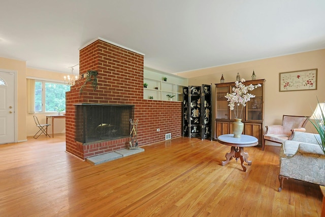 120 Locust Dr, Nyack, NY 10960 - living room featuring wood finished floors, a fireplace, and a chandelier