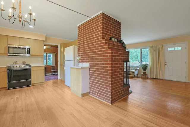 120 Locust Dr, Nyack, NY 10960 - kitchen with stove, stainless steel microwave, light wood finished floors, and plenty of natural light