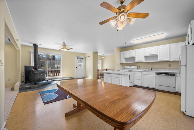 44 Nottingham Gate Rd, Rock Hill, NY 12775 - dining room with a wood stove, light wood-style flooring, and ceiling fan