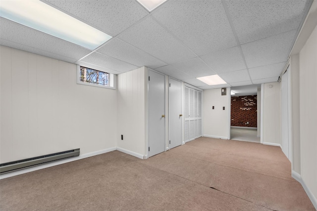44 Nottingham Gate Rd, Rock Hill, NY 12775 - below grade area featuring a paneled ceiling, a baseboard heating unit, baseboards, and carpet