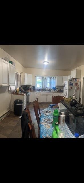 kitchen featuring white cabinetry and white appliances