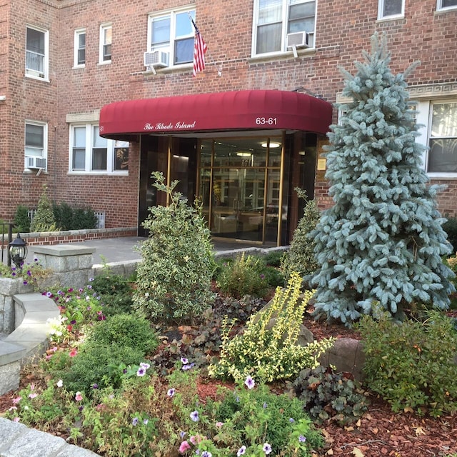 63-61 99th St Unit A4, Rego Park, NY 11374 - doorway to property with brick siding and cooling unit