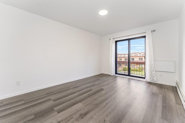 empty room featuring dark wood-type flooring, a baseboard radiator, and baseboards