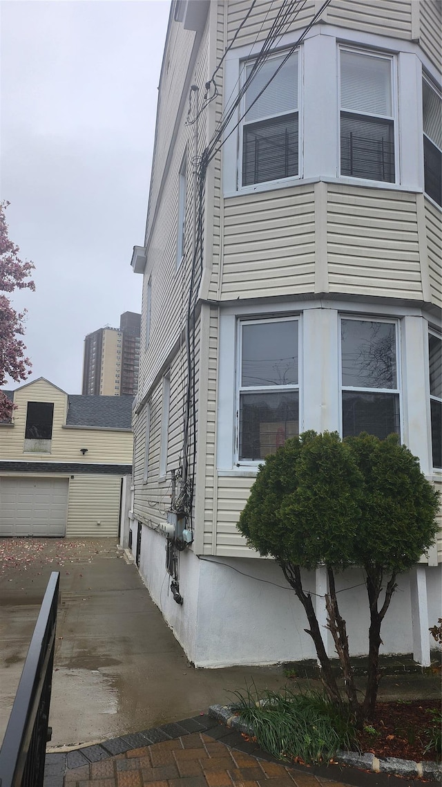 846 215th St E, Bronx, NY 10467 - view of side of property featuring an outbuilding and concrete driveway
