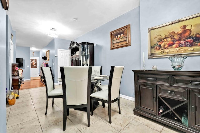 dining space with light tile patterned floors and baseboards
