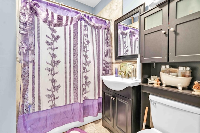 full bath with toilet, curtained shower, vanity, and tile patterned flooring