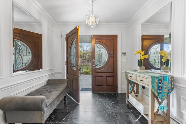 187 Jackson Ave, Pelham, NY 10803 - entrance foyer featuring a decorative wall, crown molding, marble finish floor, an inviting chandelier, and a wainscoted wall