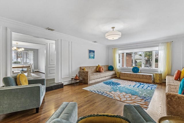 187 Jackson Ave, Pelham, NY 10803 - living room with wood finished floors, crown molding, and an inviting chandelier