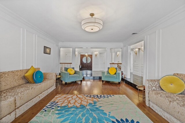 187 Jackson Ave, Pelham, NY 10803 - living room with crown molding, wood finished floors, visible vents, and ornate columns