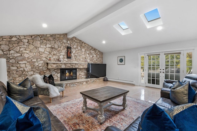 187 Jackson Ave, Pelham, NY 10803 - living area with a baseboard heating unit, french doors, a stone fireplace, and vaulted ceiling with skylight