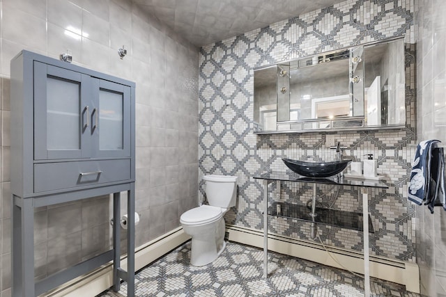 187 Jackson Ave, Pelham, NY 10803 - bathroom with a sink, toilet, tile walls, baseboard heating, and tile patterned flooring