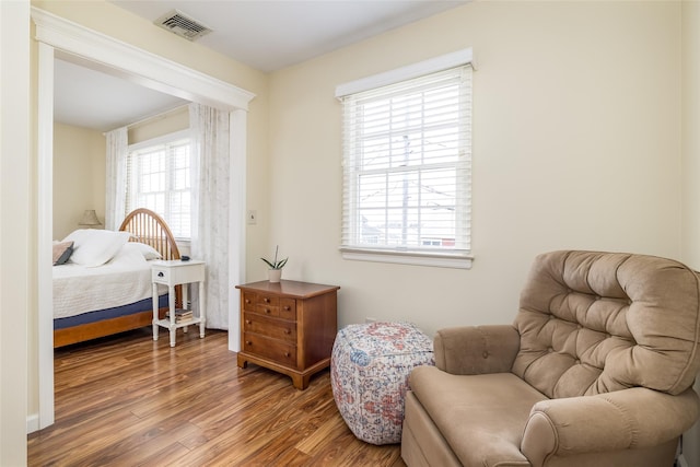 sitting room featuring visible vents and wood finished floors