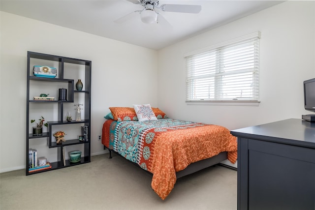 bedroom featuring ceiling fan, baseboards, and light carpet