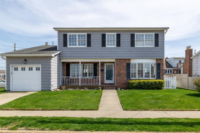 view of front of house featuring concrete driveway, a front yard, an attached garage, fence, and a porch