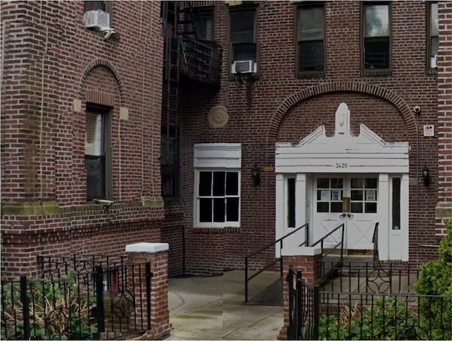 exterior space with fence and brick siding