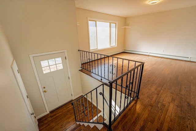interior space featuring a healthy amount of sunlight, a baseboard radiator, and wood finished floors