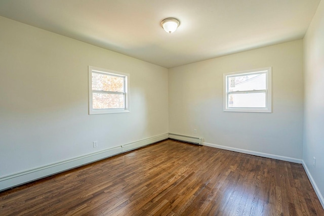 empty room with a baseboard radiator, a healthy amount of sunlight, baseboards, and dark wood-style floors