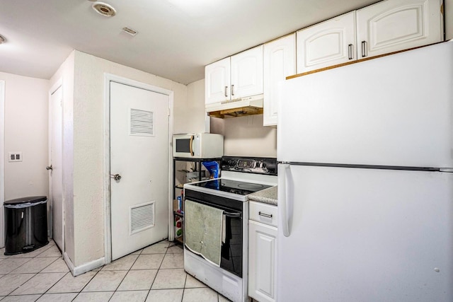 kitchen with white appliances, white cabinets, visible vents, under cabinet range hood, and light tile patterned flooring
