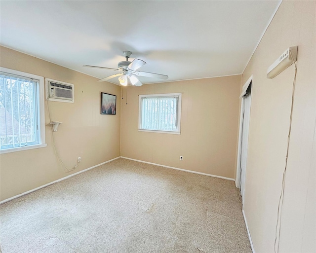 unfurnished room with carpet flooring, ceiling fan, a wall mounted AC, and baseboards