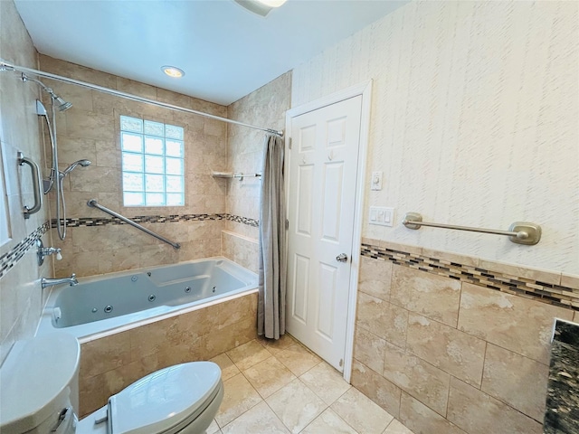full bathroom featuring tile patterned floors, a combined bath / shower with jetted tub, tile walls, and toilet