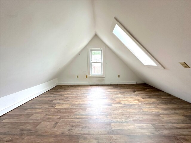 bonus room featuring wood finished floors and lofted ceiling with skylight