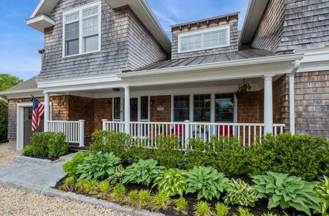 8 Hilltop Dr, Bayville, NY 11709 - doorway to property featuring a standing seam roof, a porch, and metal roof