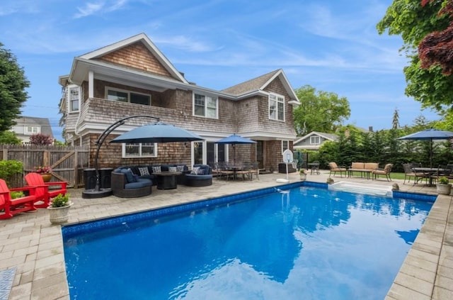 8 Hilltop Dr, Bayville, NY 11709 - rear view of property with an outdoor living space, fence, a fenced in pool, and a patio