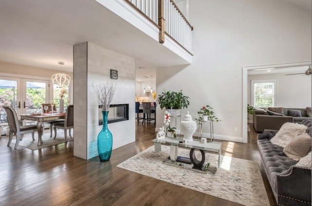 8 Hilltop Dr, Bayville, NY 11709 - living area featuring ceiling fan, a high ceiling, baseboards, and wood finished floors