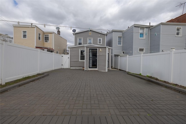 97-14 88th St, Ozone Park, NY 11416 - back of house featuring a patio area, a fenced backyard, and a residential view