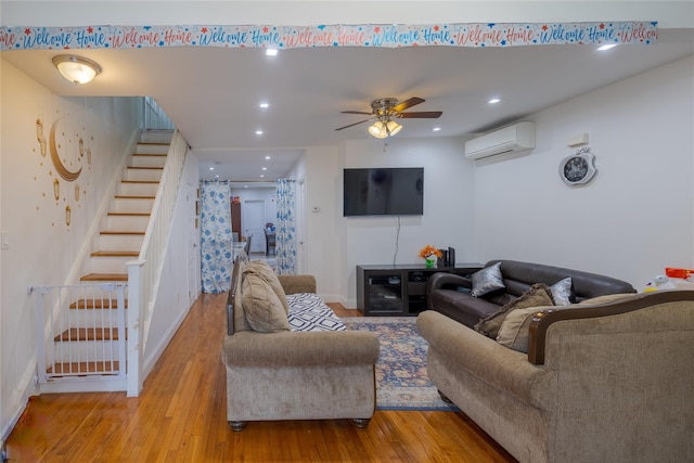 97-14 88th St, Ozone Park, NY 11416 - living room with baseboards, wood finished floors, stairs, ceiling fan, and a wall mounted AC