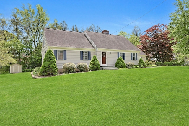 12 Heath Rd, Valhalla, NY 10595 - view of front facade featuring a chimney, a storage unit, a front yard, and an outdoor structure