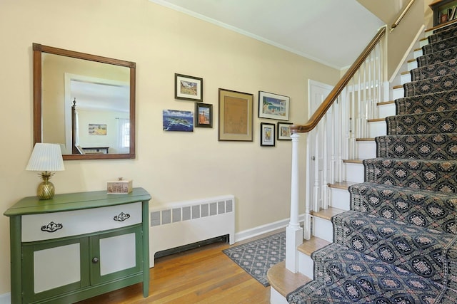 12 Heath Rd, Valhalla, NY 10595 - staircase with radiator heating unit, wood finished floors, crown molding, and baseboards