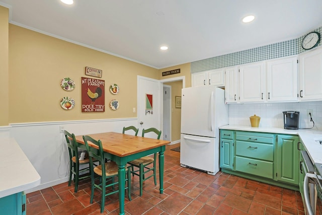 12 Heath Rd, Valhalla, NY 10595 - kitchen featuring freestanding refrigerator, white cabinets, light countertops, crown molding, and a wainscoted wall