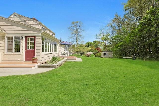 12 Heath Rd, Valhalla, NY 10595 - view of grassy yard featuring a storage shed, an outdoor structure, and a patio