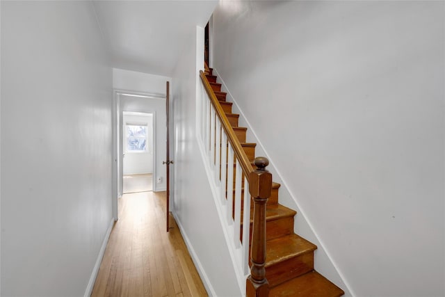 stairs featuring baseboards and wood finished floors
