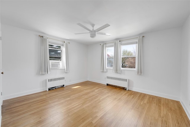 unfurnished room featuring a healthy amount of sunlight, ceiling fan, and radiator