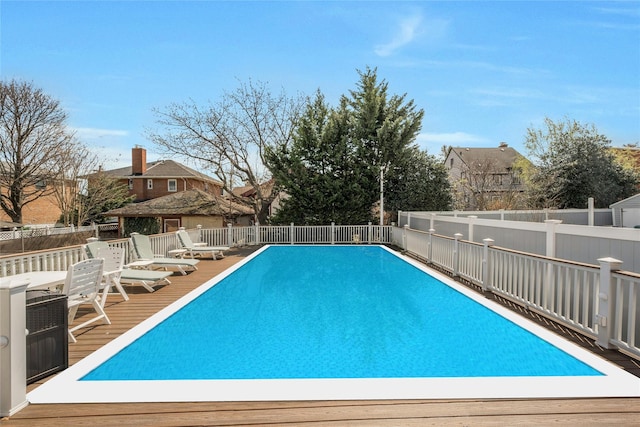 view of pool with a wooden deck, fence, and a fenced in pool