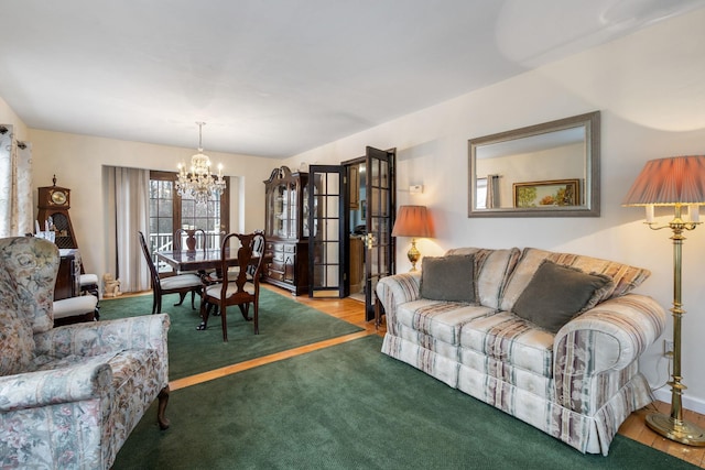 living area with a notable chandelier and carpet floors