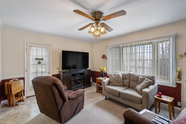 living area featuring ornamental molding, a healthy amount of sunlight, and ceiling fan