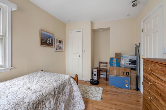 bedroom featuring baseboards and light wood-style flooring