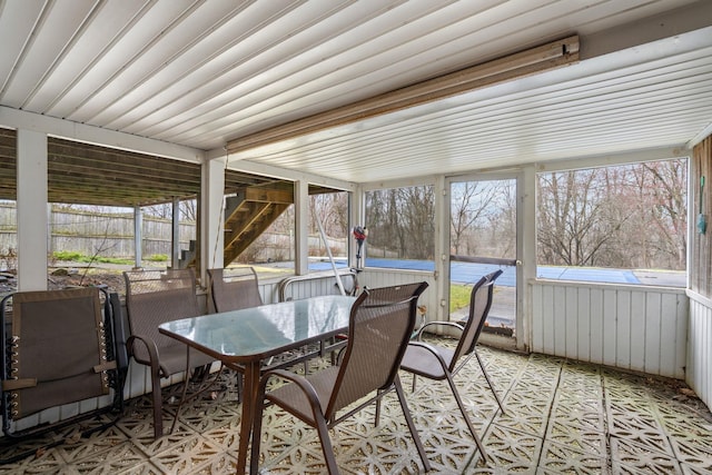 sunroom featuring outdoor dining space and a jacuzzi
