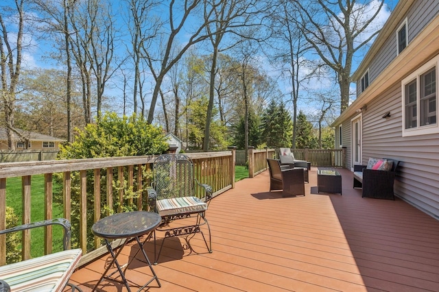 wooden terrace with fence and an outdoor hangout area