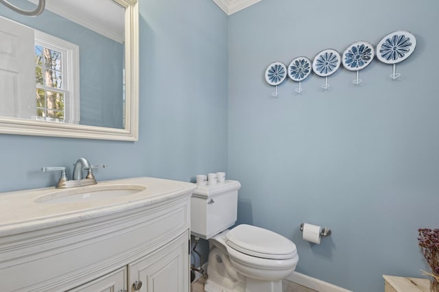 half bathroom featuring crown molding, baseboards, toilet, and vanity