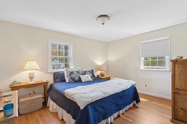 bedroom featuring baseboards and light wood-style flooring