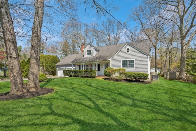 cape cod home featuring covered porch, a chimney, an attached garage, and a front lawn